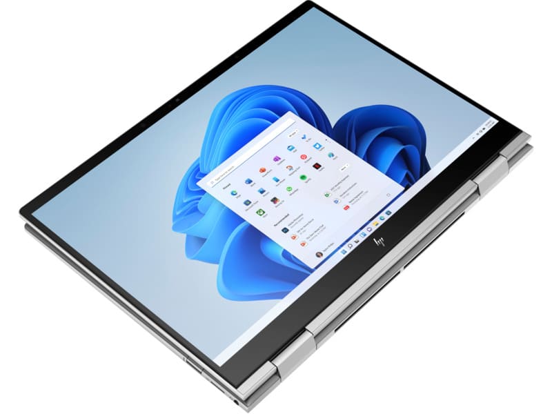 HP Envy 16 laptop in silver finish with visible keyboard and Windows desktop displayed on screen