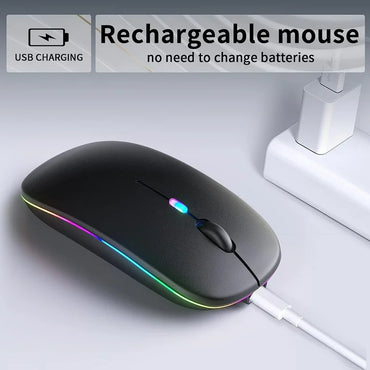 A black wireless rechargeable mouse with multicolor LED lighting, being charged via USB.
