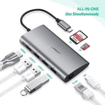 Portable 8-in-1 Type-C hub with multiple gadgets around it