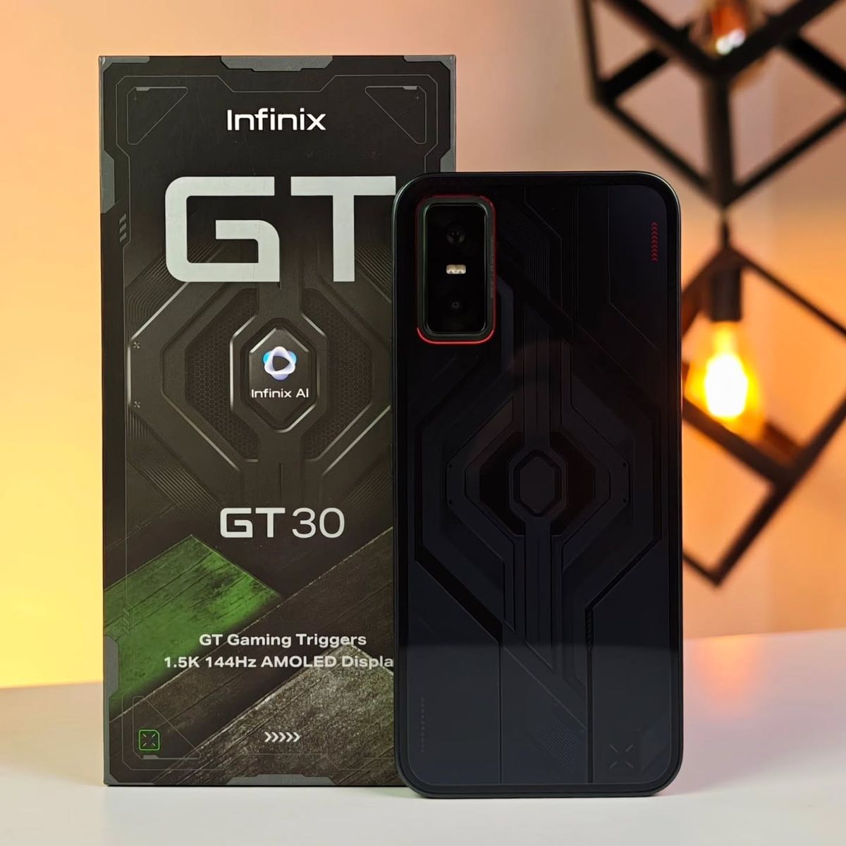 Infinix GT 30 Pro in Dark Flare beside the retail box