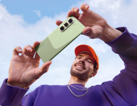 Infinix Hot 50 Pro Plus green two-tone back held up against the sky