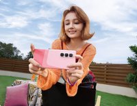Infinix Hot 50 Pro Plus pink two-tone back held for a selfie