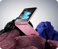 Infinix Zero Flip in Blossom Glow closed, cover screen facing up on a rock