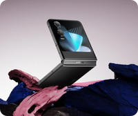 Infinix Zero Flip in Rock Black closed, cover screen facing up on a rock
