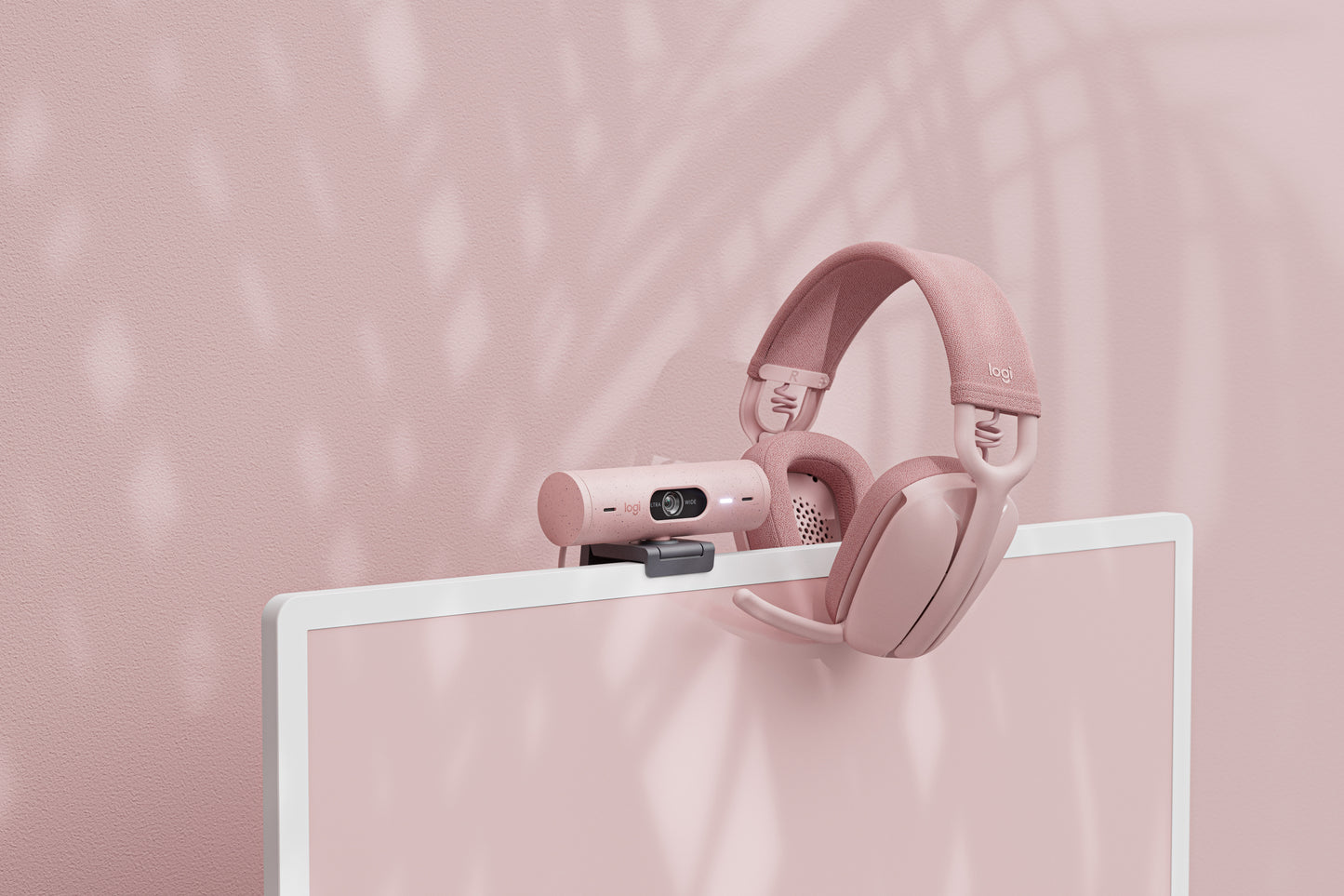 Pink Logitech Brio 500 with Pink Headsets on it's right