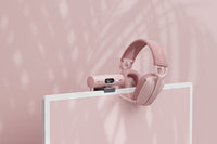 Pink Logitech Brio 500 with Pink Headsets on it's right