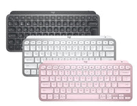 An image showing three Logitech MX Keys Mini wireless keyboards in pink, gray, and white colors, displayed in an overlapped fashion.