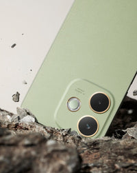 OPPO A5 Pro Olive Green camera island close-up on rock, showing the 50MP dual module