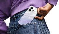 Redmi Note 14 in mist purple, back with a wavy finish sitting in a jeans pocket
