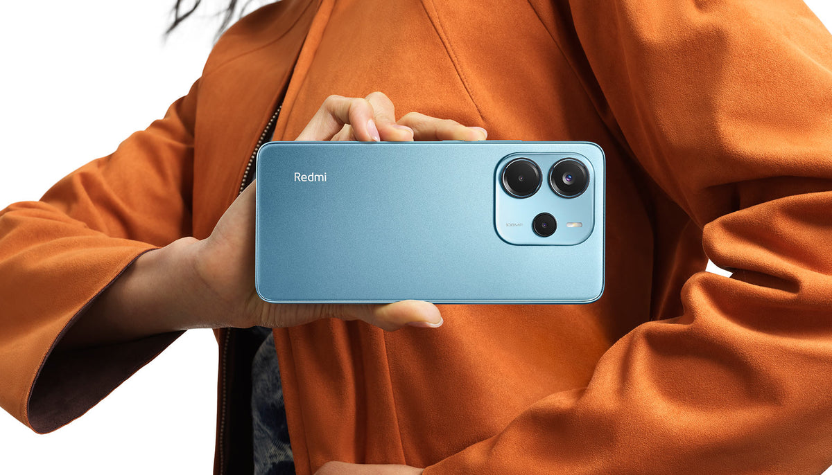 Redmi Note 14 in ocean blue, back view with the triple camera held up
