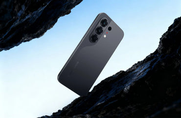Tecno Camon 50 in moonshadow black, back view above dark rock
